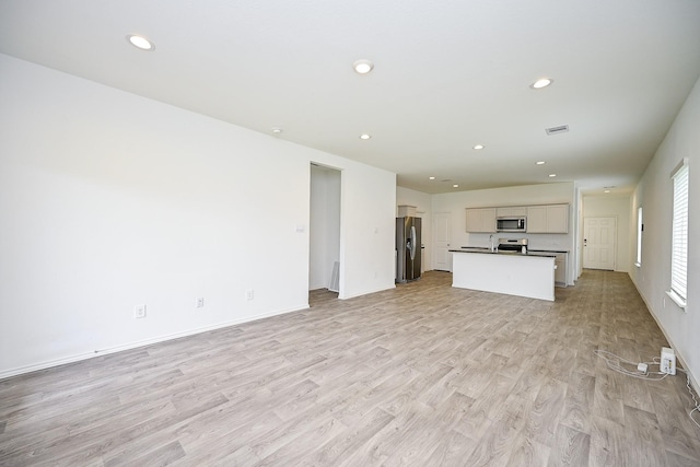 5411 Auburn Gardens Ct, Spring, TX 77373 - unfurnished living room with light wood finished floors and recessed lighting