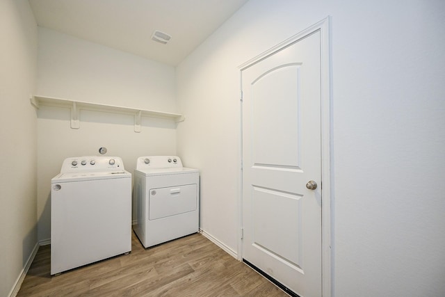 5411 Auburn Gardens Ct, Spring, TX 77373 - washroom featuring washing machine and clothes dryer and light wood-style flooring