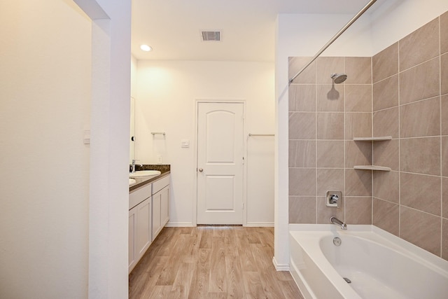 5411 Auburn Gardens Ct, Spring, TX 77373 - bathroom featuring vanity, wood finished floors,  shower combination, and recessed lighting