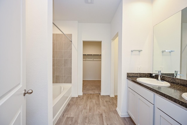 5411 Auburn Gardens Ct, Spring, TX 77373 - full bath with double vanity, wood finished floors, bathtub / shower combination, and a spacious closet