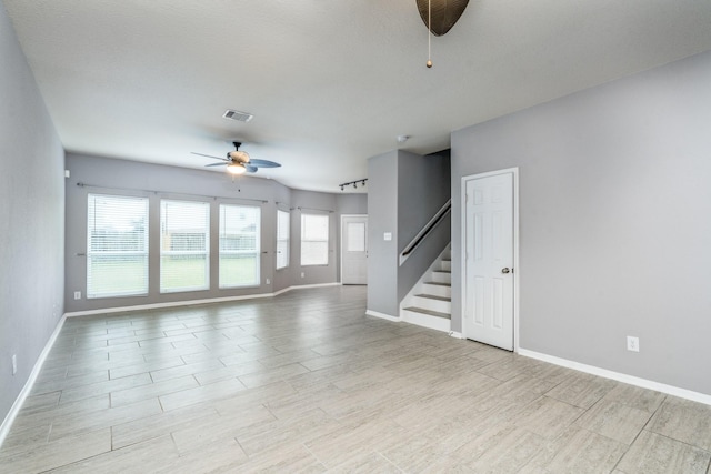 20027 Bayliss Manor Ln, Cypress, TX 77433 - unfurnished living room with a ceiling fan, stairway, and light wood-style flooring