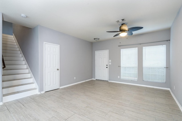 20027 Bayliss Manor Ln, Cypress, TX 77433 - unfurnished living room with a ceiling fan, stairway, and light wood finished floors