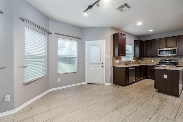 20027 Bayliss Manor Ln, Cypress, TX 77433 - kitchen featuring appliances with stainless steel finishes, dark brown cabinets, backsplash, and recessed lighting