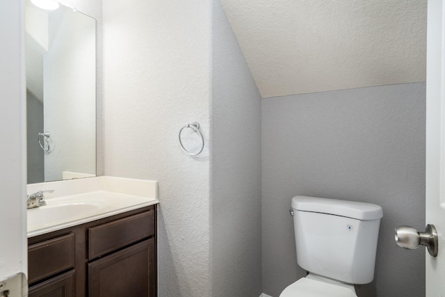 20027 Bayliss Manor Ln, Cypress, TX 77433 - half bath with vaulted ceiling, vanity, and a textured wall