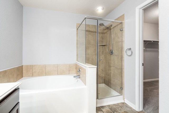 20027 Bayliss Manor Ln, Cypress, TX 77433 - full bathroom featuring a shower stall, a bath, a spacious closet, and vanity