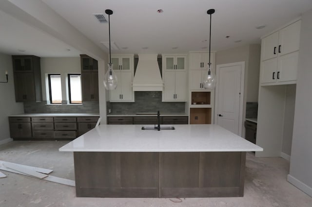 3510 Azure Ct, Richmond, TX 77406 - kitchen featuring premium range hood, tasteful backsplash, a spacious island, white cabinets, and stovetop
