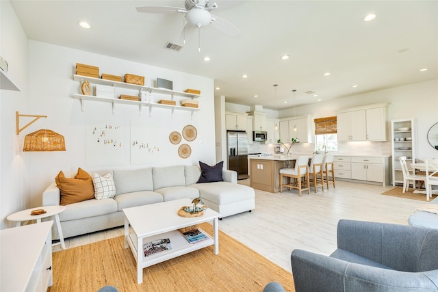 2401 103rd St, Galveston, TX 77554 - living area with a ceiling fan, recessed lighting, and light wood-type flooring