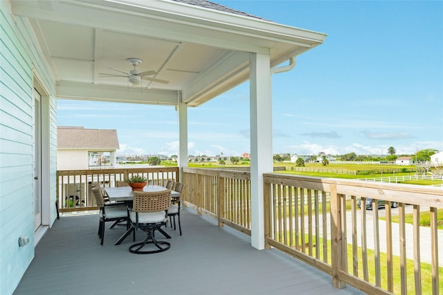 2401 103rd St, Galveston, TX 77554 - wooden deck with ceiling fan and outdoor dining space