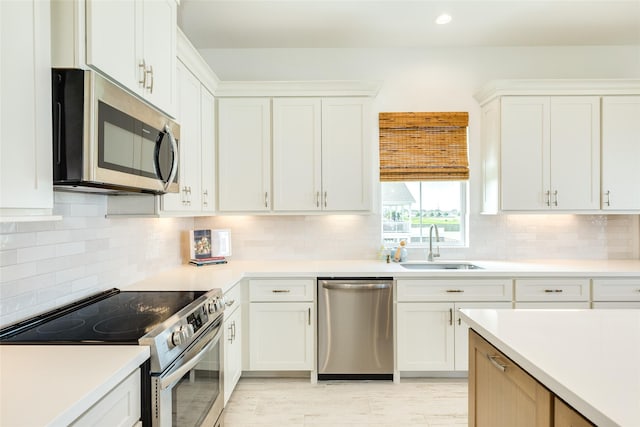 2401 103rd St, Galveston, TX 77554 - kitchen with appliances with stainless steel finishes, light countertops, white cabinetry, tasteful backsplash, and recessed lighting