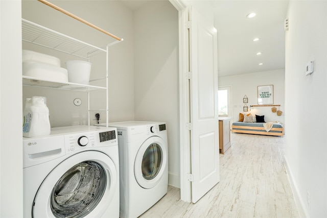 2401 103rd St, Galveston, TX 77554 - laundry room featuring washing machine and clothes dryer, light wood-style floors, and recessed lighting
