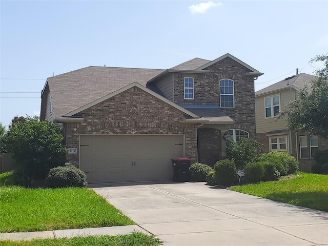 2714 Glenfield Manor Ln, Houston, TX 77014 - traditional-style house featuring driveway, a garage, brick siding, and a front yard