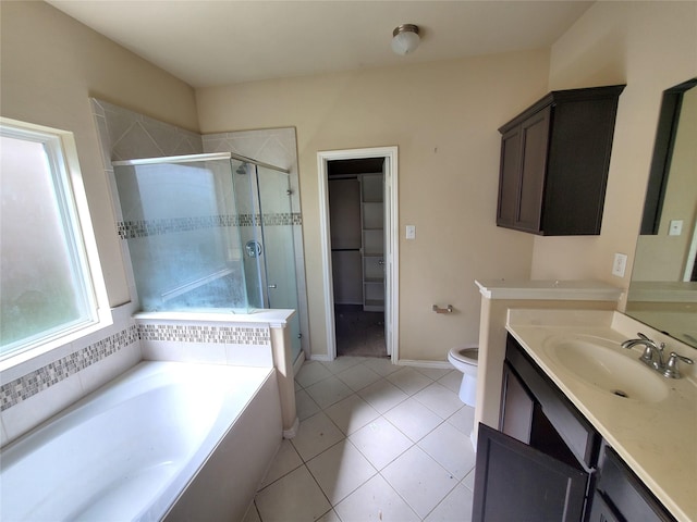 2714 Glenfield Manor Ln, Houston, TX 77014 - bathroom featuring a stall shower, vanity, a garden tub, tile patterned flooring, and a spacious closet