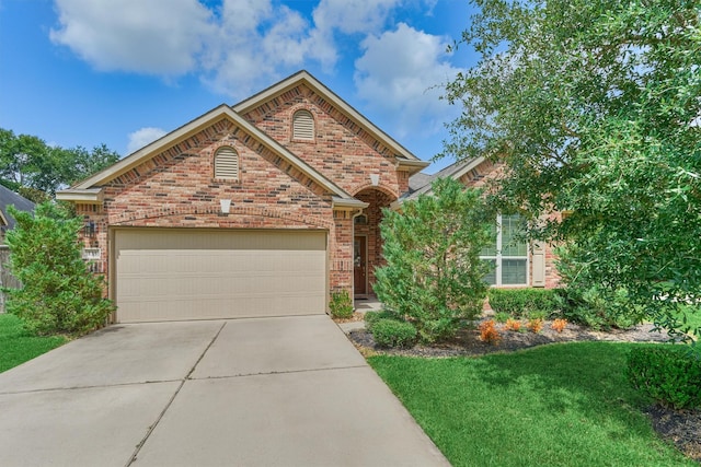135 Forest Heights Way, Montgomery, TX 77316 - view of front of home with brick siding, an attached garage, driveway, and a front lawn