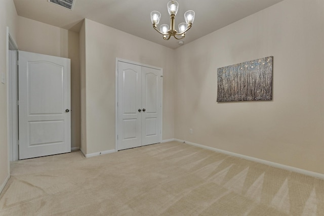 135 Forest Heights Way, Montgomery, TX 77316 - unfurnished bedroom featuring carpet, a chandelier, and a closet
