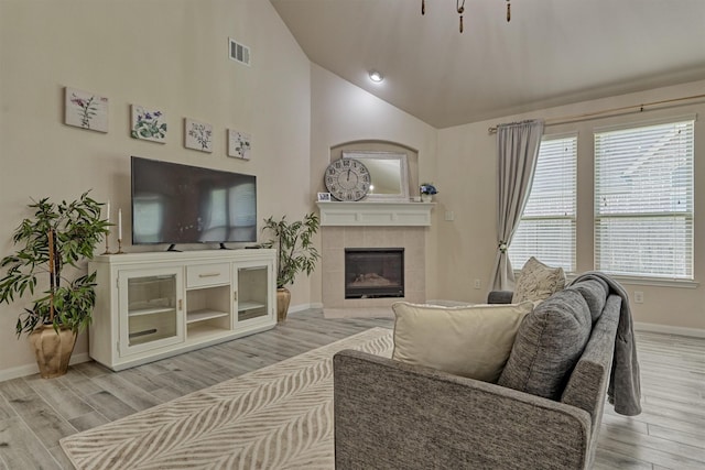 135 Forest Heights Way, Montgomery, TX 77316 - living room with light wood-style flooring, a fireplace, and high vaulted ceiling