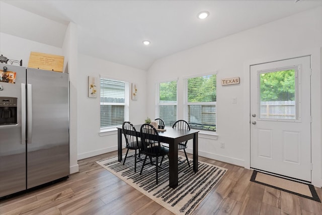 21635 Alberta Forest Cir, Magnolia, TX 77355 - dining area featuring healthy amount of natural light, light wood-style flooring, lofted ceiling, and recessed lighting