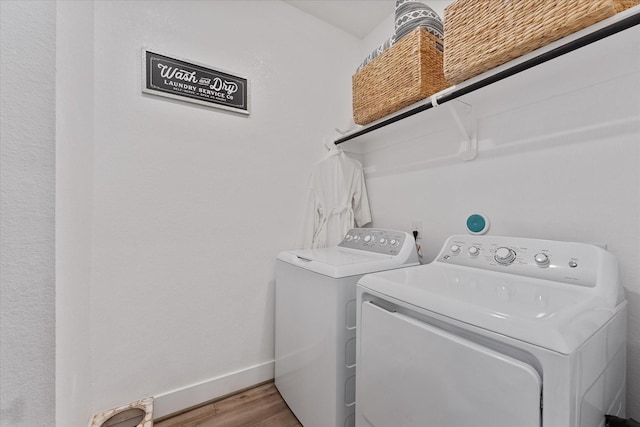 21635 Alberta Forest Cir, Magnolia, TX 77355 - washroom featuring washer and clothes dryer and wood finished floors