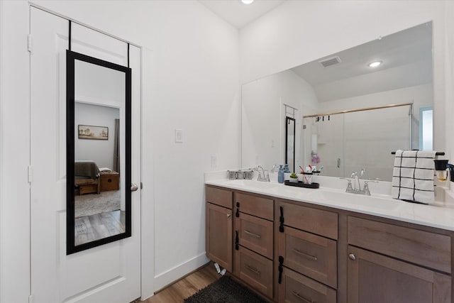 21635 Alberta Forest Cir, Magnolia, TX 77355 - bathroom with a stall shower, double vanity, and wood finished floors