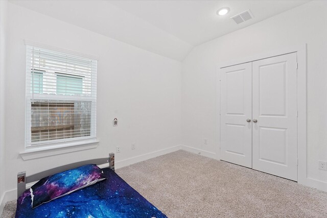 21635 Alberta Forest Cir, Magnolia, TX 77355 - unfurnished bedroom featuring carpet, vaulted ceiling, recessed lighting, and a closet