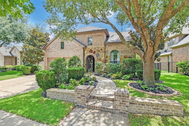 18415 Pin Oak Bend Dr, Cypress, TX 77433 - french country style house with brick siding, driveway, an attached garage, and a shingled roof