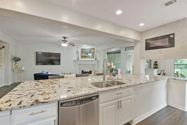 18415 Pin Oak Bend Dr, Cypress, TX 77433 - kitchen featuring stainless steel dishwasher, dark wood-style flooring, open floor plan, ceiling fan, and light stone counters