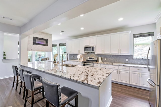 18415 Pin Oak Bend Dr, Cypress, TX 77433 - kitchen featuring stainless steel appliances, dark wood-style floors, white cabinetry, decorative backsplash, and recessed lighting