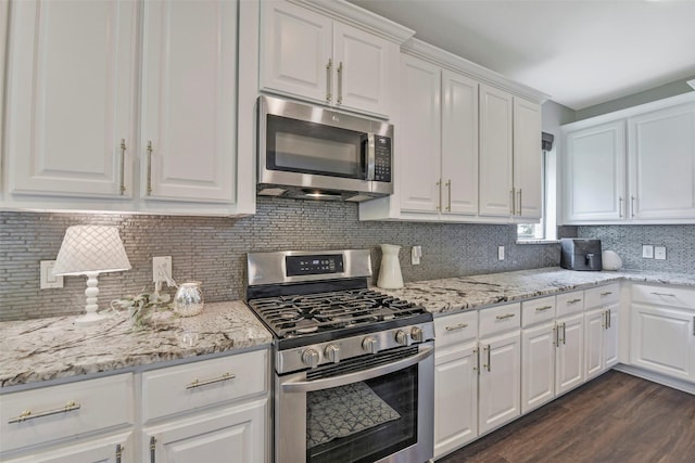 18415 Pin Oak Bend Dr, Cypress, TX 77433 - kitchen featuring appliances with stainless steel finishes, white cabinets, tasteful backsplash, dark wood-type flooring, and light stone counters
