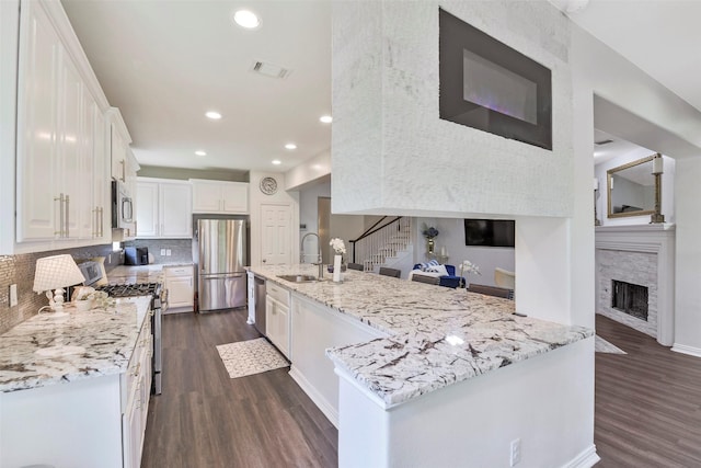 18415 Pin Oak Bend Dr, Cypress, TX 77433 - kitchen featuring stainless steel appliances, dark wood-style flooring, white cabinets, tasteful backsplash, and recessed lighting