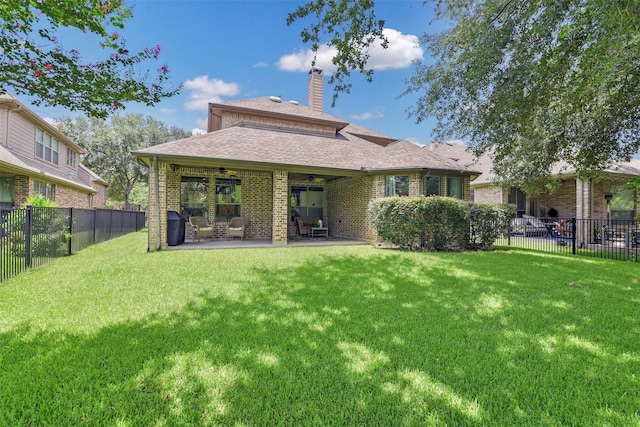 18415 Pin Oak Bend Dr, Cypress, TX 77433 - back of property featuring a ceiling fan, a fenced backyard, a chimney, brick siding, and a patio area
