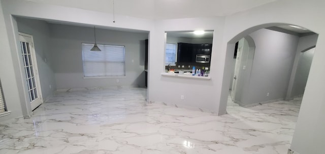 71 N Forrest Ave, La Porte, TX 77571 - empty room featuring arched walkways and marble finish floors
