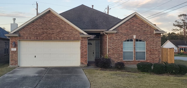 71 N Forrest Ave, La Porte, TX 77571 - view of front facade featuring brick siding, concrete driveway, a shingled roof, a garage, and a front yard