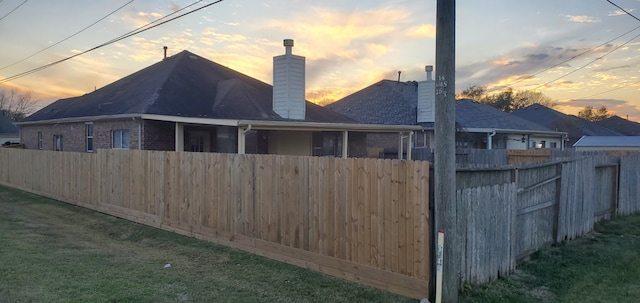71 N Forrest Ave, La Porte, TX 77571 - property exterior at dusk featuring a chimney and brick siding