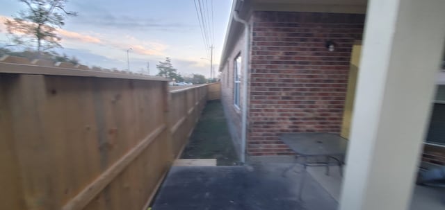 71 N Forrest Ave, La Porte, TX 77571 - property exterior at dusk with brick siding and a balcony