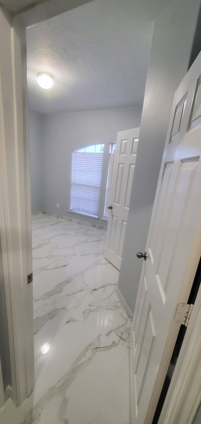 71 N Forrest Ave, La Porte, TX 77571 - hallway featuring a textured ceiling and marble finish floors