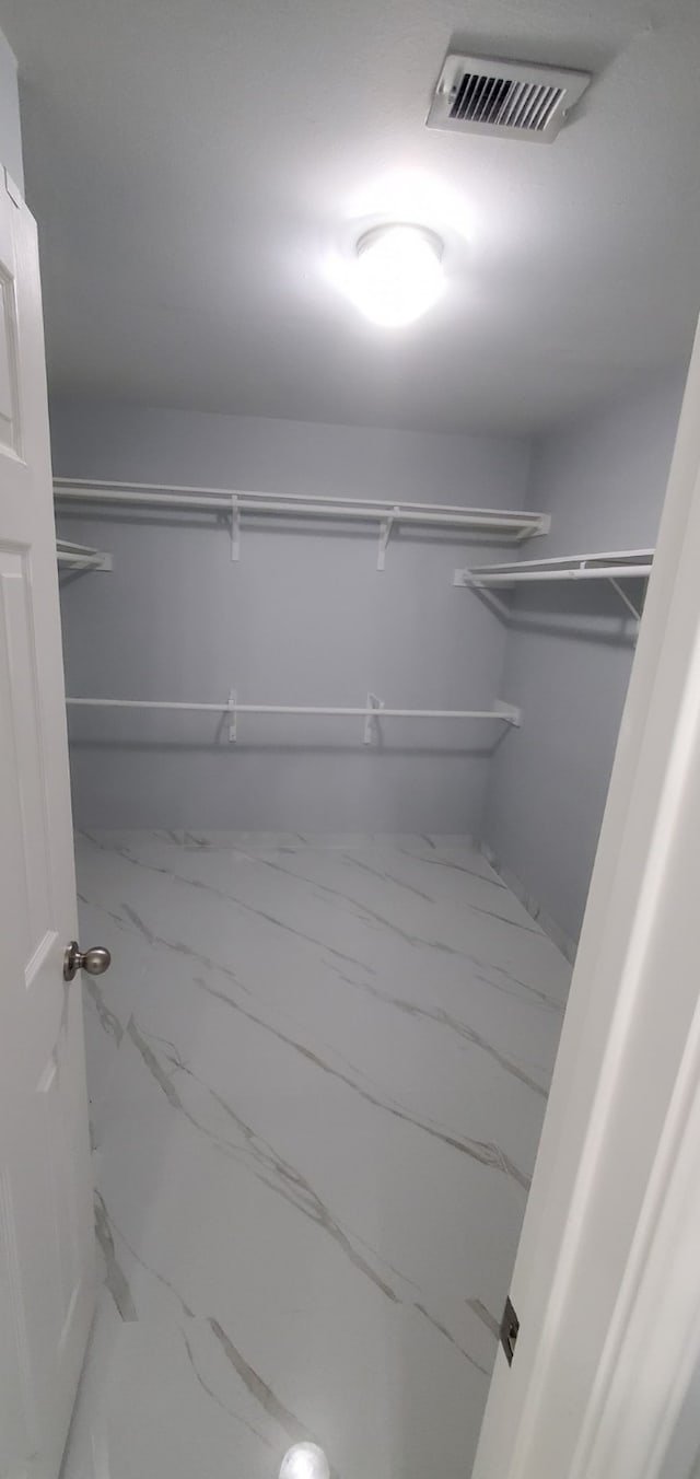 71 N Forrest Ave, La Porte, TX 77571 - spacious closet featuring marble look tiles