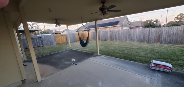 71 N Forrest Ave, La Porte, TX 77571 - patio terrace at dusk with a ceiling fan, a fenced backyard, and a patio area