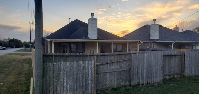 71 N Forrest Ave, La Porte, TX 77571 - back of house at dusk with a chimney