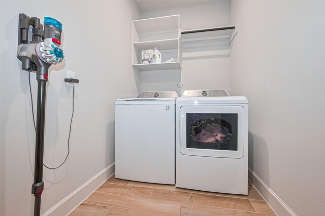 7522 Zion Grove Ct, Katy, TX 77493 - laundry area with separate washer and dryer and wood finish floors