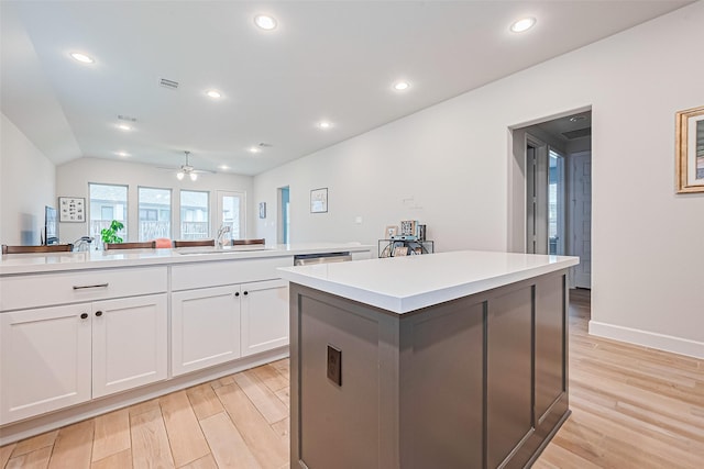 7522 Zion Grove Ct, Katy, TX 77493 - kitchen featuring light wood finished floors, a kitchen island, light countertops, recessed lighting, and vaulted ceiling