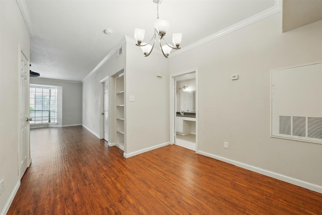 2255 Braeswood Park Dr Unit 181, Houston, TX 77030 - unfurnished room with a chandelier, crown molding, wood finished floors, built in features, and a smoke detector