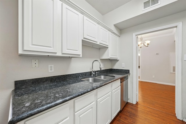 2255 Braeswood Park Dr Unit 181, Houston, TX 77030 - kitchen featuring stainless steel dishwasher, white cabinets, dark wood-style floors, a chandelier, and dark stone counters