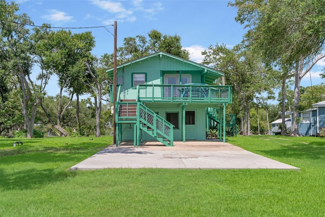 1040 County Road 206, Sargent, TX 77414 - back of property featuring stairs, a patio, a yard, and a wooden deck
