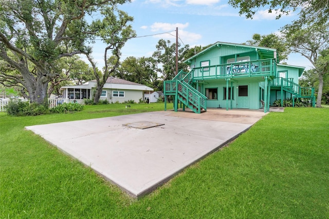 1040 County Road 206, Sargent, TX 77414 - back of property featuring stairway, a lawn, and driveway