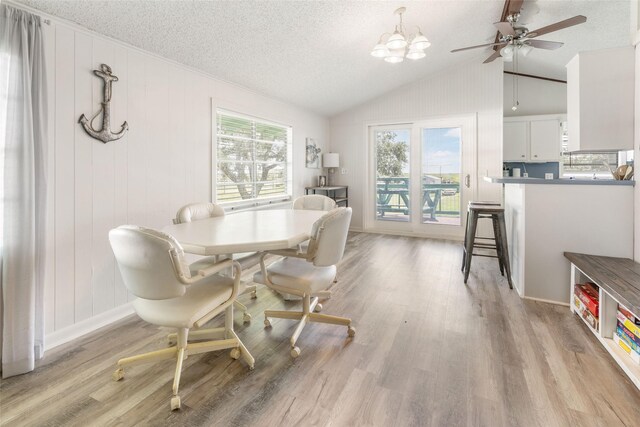 1040 County Road 206, Sargent, TX 77414 - dining space featuring lofted ceiling, light wood-style floors, ceiling fan, a textured ceiling, and a chandelier