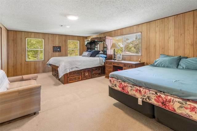 1040 County Road 206, Sargent, TX 77414 - bedroom featuring carpet floors, wood walls, and a textured ceiling
