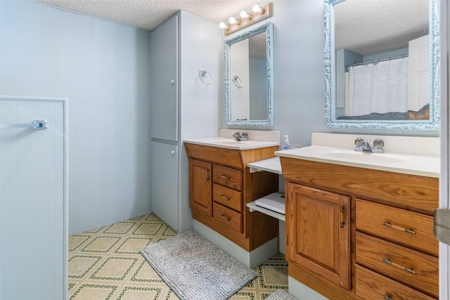 1040 County Road 206, Sargent, TX 77414 - full bathroom featuring a textured ceiling and two vanities