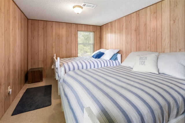 1040 County Road 206, Sargent, TX 77414 - bedroom featuring a textured ceiling, carpet, and wooden walls