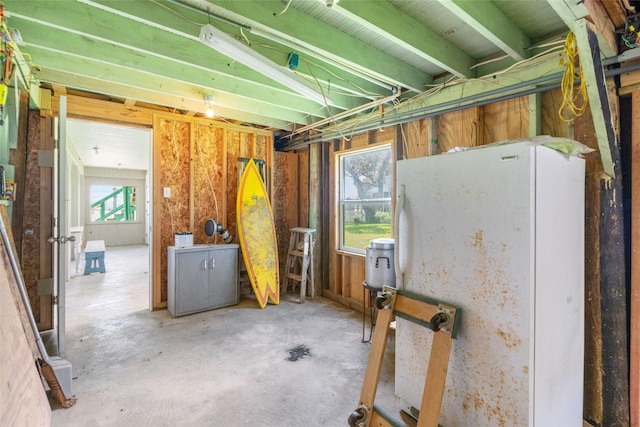1040 County Road 206, Sargent, TX 77414 - below grade area with freestanding refrigerator and healthy amount of natural light