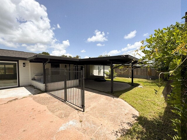 2630 34th St, Port Arthur, TX 77640 - view of patio / terrace with an attached carport and concrete driveway