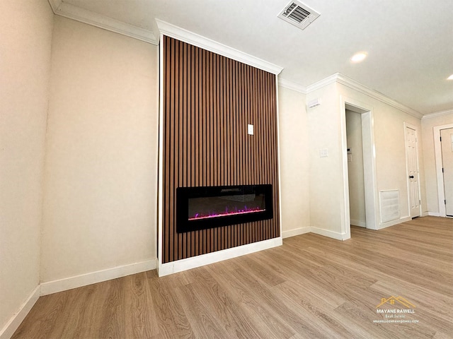 2630 34th St, Port Arthur, TX 77640 - unfurnished living room featuring wood finished floors, a glass covered fireplace, ornamental molding, and recessed lighting